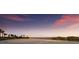 Sandy beach with palm trees and waterfront views at sunset at 1902 4Th E St, Palmetto, FL 34221