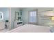 Bright bedroom with a white bed frame, aqua walls, and an en-suite bathroom at 1902 4Th E St, Palmetto, FL 34221