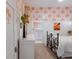 Cozy bedroom with tropical wallpaper, white wainscoting and trim, and a wrought iron bed frame at 1902 4Th E St, Palmetto, FL 34221