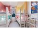 Fun bedroom featuring bunk beds with colorful striped walls and playful decor at 1902 4Th E St, Palmetto, FL 34221