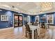 Community room with multiple tables, a television, and a door leading to a patio at 1902 4Th E St, Palmetto, FL 34221