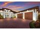 Elegant home features a brick driveway, well-manicured landscaping, and a spacious three-car garage at 1902 4Th E St, Palmetto, FL 34221