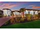 Beautifully landscaped home with a brick driveway, mature palm trees, and elegant exterior lighting at 1902 4Th E St, Palmetto, FL 34221