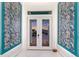 Elegant foyer features marble floors, artistic wall decor, and a glimpse of the exterior through double doors at 1902 4Th E St, Palmetto, FL 34221