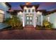 Grand front entrance featuring double doors, manicured landscaping, and a welcoming facade at 1902 4Th E St, Palmetto, FL 34221