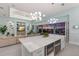 Open concept kitchen featuring an island, stainless steel appliances, and an adjacent living room at 1902 4Th E St, Palmetto, FL 34221