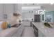Modern kitchen featuring sleek countertops, white cabinets, and stainless steel appliances at 1902 4Th E St, Palmetto, FL 34221