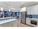 Modern kitchen with stainless steel appliances and white cabinets adjacent to the lounge at 1902 4Th E St, Palmetto, FL 34221