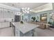 Open-concept kitchen with a large island, stainless steel appliances, and an adjacent living space at 1902 4Th E St, Palmetto, FL 34221