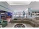 Spacious living room adjacent to the bar and kitchen area features modern lighting and ample seating at 1902 4Th E St, Palmetto, FL 34221
