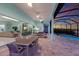 Covered outdoor space with seamless access to the pool, living room, and dining area at 1902 4Th E St, Palmetto, FL 34221