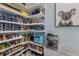 Organized walk-in pantry with white shelving, stocked with food, small appliances, and a charming koala picture at 1902 4Th E St, Palmetto, FL 34221