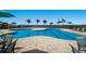 Community pool and deck with lounge chairs, a hot tub, and palm trees overlooking the marina at 1902 4Th E St, Palmetto, FL 34221