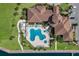 An aerial view shows a luxury community pool and spa with views of the clubhouse at 1902 4Th E St, Palmetto, FL 34221