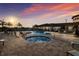 Community pool and hot tub area with poolside seating and lush landscaping at 1902 4Th E St, Palmetto, FL 34221