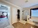 Bathroom with shower, tub, and access to walk-in closet at 19029 Chislehurst Dr, Land O Lakes, FL 34638