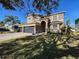 Two-story house with a three-car garage and landscaped yard at 19029 Chislehurst Dr, Land O Lakes, FL 34638
