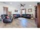 Bright living room featuring a sectional sofa and ceiling fan at 19029 Chislehurst Dr, Land O Lakes, FL 34638