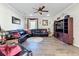 Living room with sectional sofa, wood floors and entertainment center at 19029 Chislehurst Dr, Land O Lakes, FL 34638