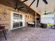 Extended covered patio with comfortable seating and a fireplace at 19029 Chislehurst Dr, Land O Lakes, FL 34638