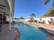 Relaxing kidney-shaped pool with patio and seating areas at 19029 Chislehurst Dr, Land O Lakes, FL 34638