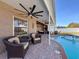 Inviting pool area with covered patio, seating, and brick pavers at 19029 Chislehurst Dr, Land O Lakes, FL 34638