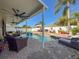 Inviting pool area with covered patio and lounge chairs at 19029 Chislehurst Dr, Land O Lakes, FL 34638