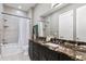 Bathroom with dark vanity, marble countertop, and shower/tub combo at 1903 Haven Bend, Tampa, FL 33613