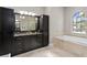 Primary bathroom with a large soaking tub, double vanity, and ample storage at 1903 Haven Bend, Tampa, FL 33613