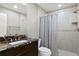 Modern bathroom with dark vanity and a shower stall at 1903 Haven Bend, Tampa, FL 33613
