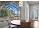 Breakfast nook with a round table and chairs, overlooking the pool and lake at 1903 Haven Bend, Tampa, FL 33613