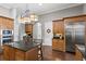Eat-in kitchen with an island, stainless steel appliances, and hardwood floors at 1903 Haven Bend, Tampa, FL 33613