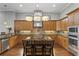 Spacious kitchen with island, stainless steel appliances, and hardwood floors at 1903 Haven Bend, Tampa, FL 33613