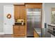 Modern kitchen features a large stainless steel refrigerator and ample wood cabinetry at 1903 Haven Bend, Tampa, FL 33613