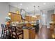 Modern kitchen featuring light wood cabinets, granite countertops, and a large island at 1903 Haven Bend, Tampa, FL 33613