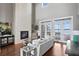 Bright living room with a large stone fireplace and lake views at 1903 Haven Bend, Tampa, FL 33613