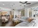 Open living room with a large sectional sofa, kitchen views, and access to a patio at 1903 Haven Bend, Tampa, FL 33613