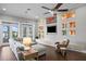 Living room with a large sectional sofa, a built-in entertainment center, and lake views at 1903 Haven Bend, Tampa, FL 33613