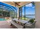 Outdoor dining area with lake view and screened porch at 1903 Haven Bend, Tampa, FL 33613