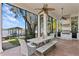 Outdoor kitchen with lake view and seating area at 1903 Haven Bend, Tampa, FL 33613