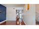 Long hallway with hardwood floors and view into the kitchen and living areas at 200 4Th S Ave # 139, St Petersburg, FL 33701