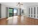 Sunlit living room features wood floors, ceiling fan, balcony access, and water views at 2109 Bayshore Blvd # 704, Tampa, FL 33606