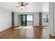 Spacious living room with wood floors, ceiling fan, and a sliding glass door to a balcony with water view at 2109 Bayshore Blvd # 704, Tampa, FL 33606
