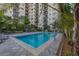 Outdoor swimming pool surrounded by landscaping and overlooking a residential building at 2109 Bayshore Blvd # 704, Tampa, FL 33606