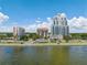 Waterfront condo buildings offer views of Tampa Bay, mature trees, and sunny skies in this drone shot at 2109 Bayshore Blvd # 704, Tampa, FL 33606