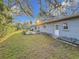 Large backyard with patio, mature trees, and lush lawn at 2446 Belleair Rd, Clearwater, FL 33764
