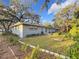 Large backyard with a grassy area and mature trees at 2446 Belleair Rd, Clearwater, FL 33764