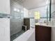 Spa-like bathroom with granite vanity, large shower and modern fixtures at 2446 Belleair Rd, Clearwater, FL 33764