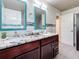 Modern bathroom boasts double sinks, granite countertop, and teal accents at 2446 Belleair Rd, Clearwater, FL 33764