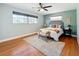 Main bedroom with hardwood floors, a ceiling fan and plenty of light at 2446 Belleair Rd, Clearwater, FL 33764